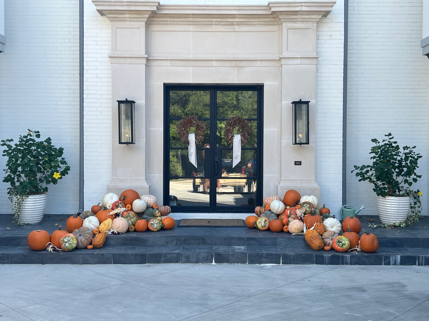 Decorative pumpkins on steps leading to a modern house